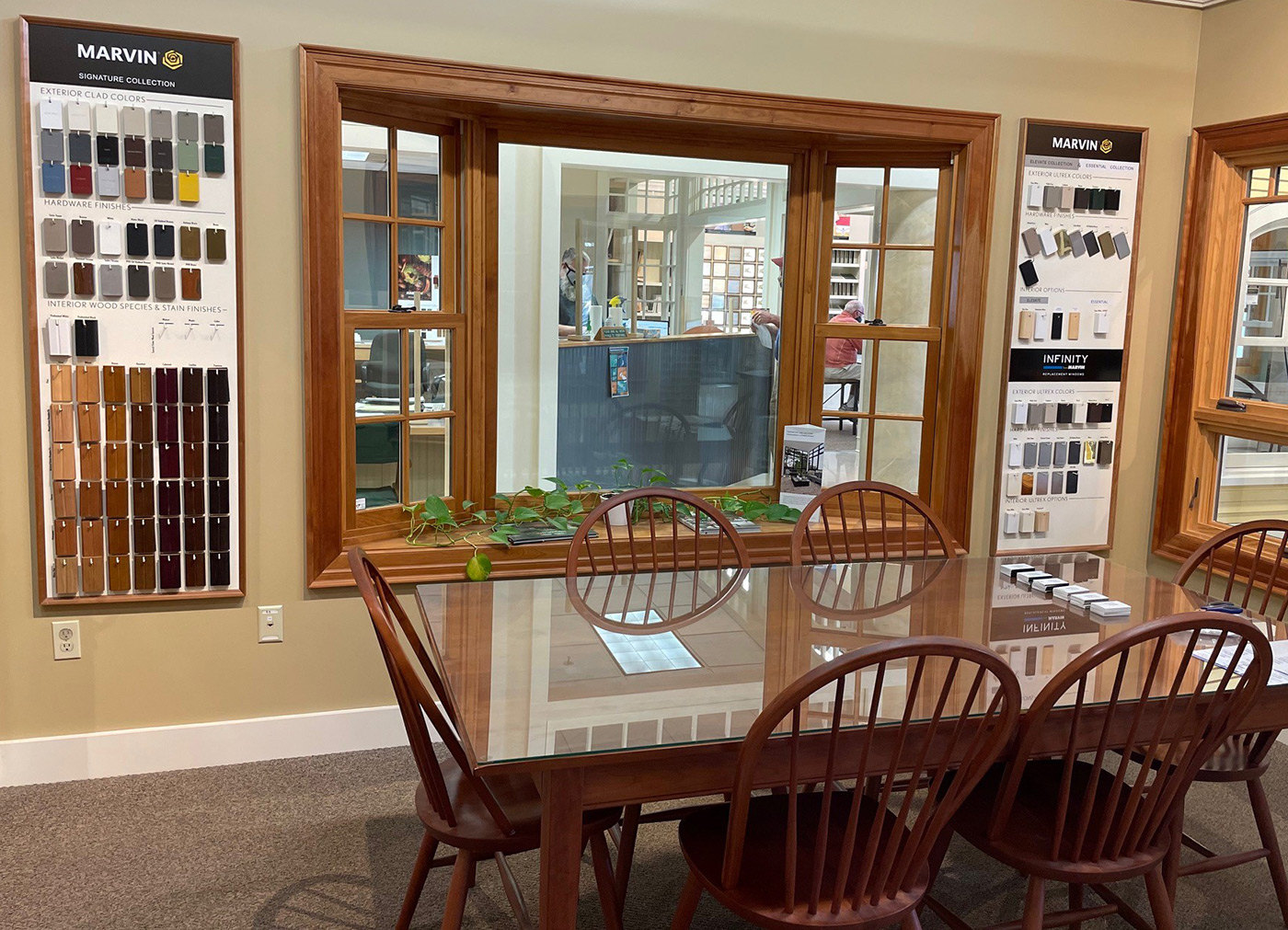 Interior of the Williston showroom with table and chairs, paint samples on wall, and windows with wood frames