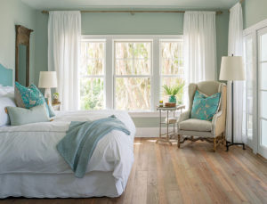 Cozy sea green and white bedroom with Marvin Elevate Collection windows with white frames
