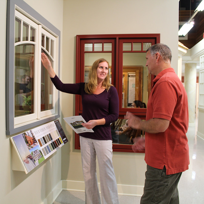 A team member and client partaking in a window design consultation