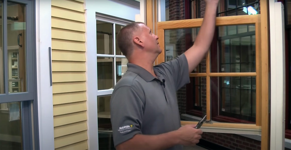 A man demonstrating Marvin window weatherstrip replacement
