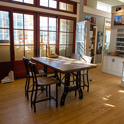 Showroom with glass doors, table, and shelves of paint samples