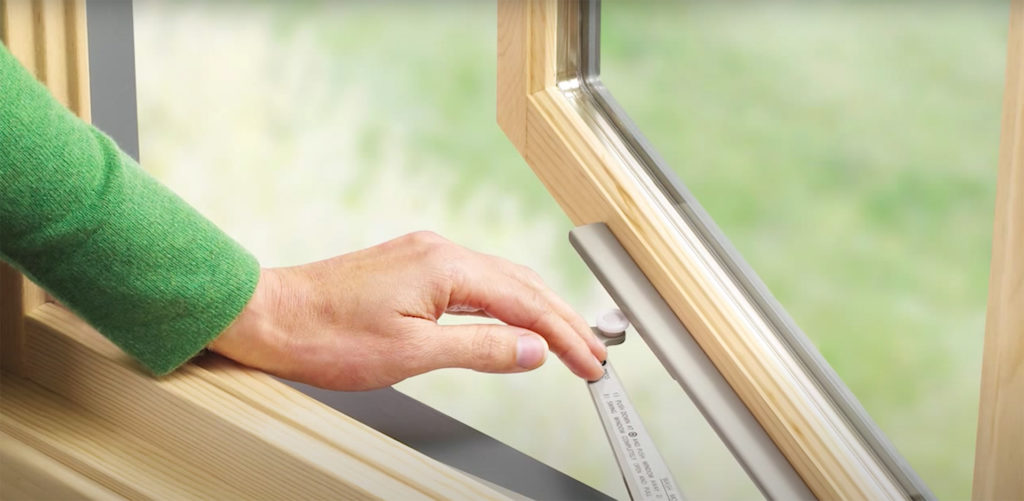 Woman's hand pushing open a Marvin Ultimate Casement Window